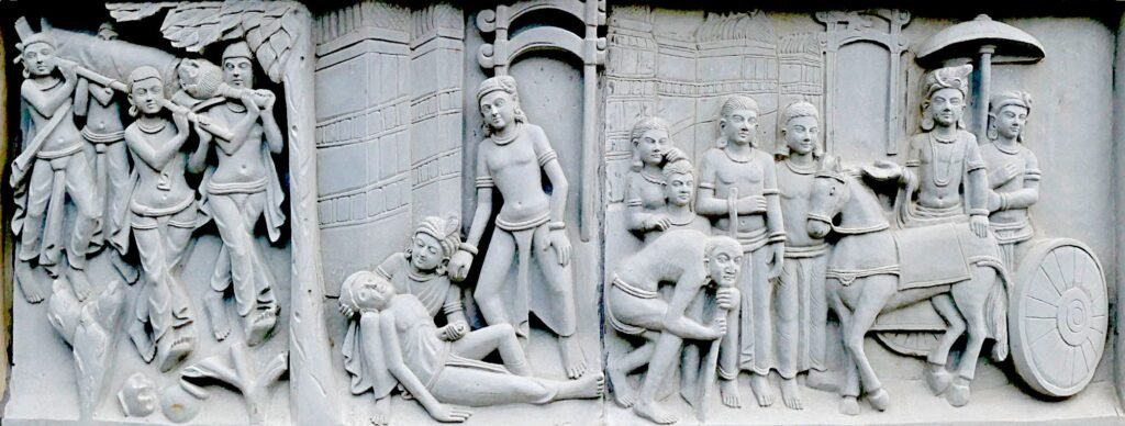 Relief sculpture at Mahabodhi Vihara in Hyderabad depicting three of the Four Sights—an old man, a sick person, and a corpse—symbolizing the existential realities that inspired Siddhartha’s search for liberation.